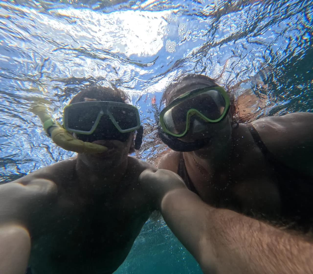 Couple scuba diving together in the clear waters of Trincomalee, Sri Lanka